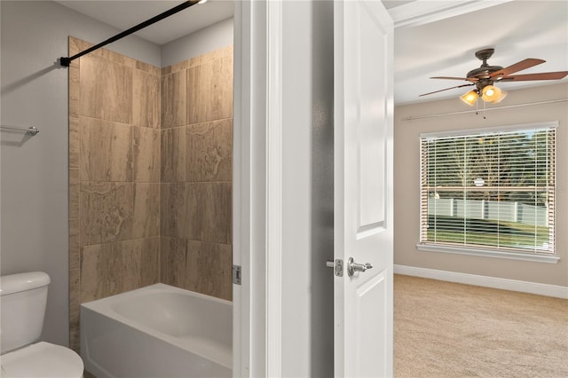 bathroom featuring a ceiling fan, shower / bath combination, toilet, and baseboards