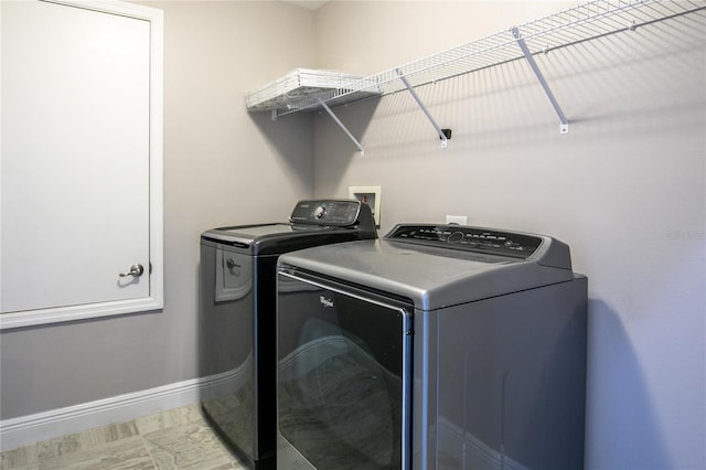 laundry area featuring laundry area, washer and clothes dryer, and baseboards