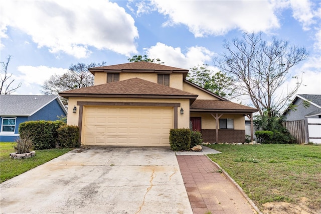 view of front of home with an attached garage, fence, driveway, stucco siding, and a front yard