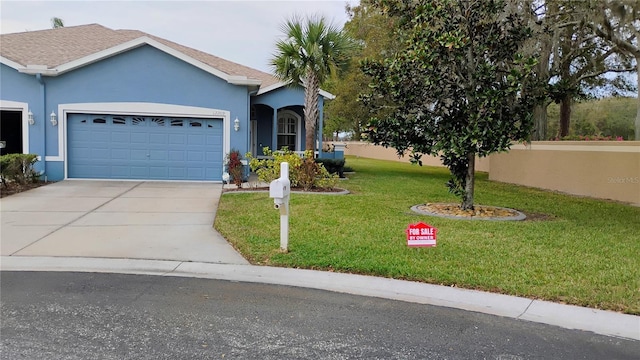 ranch-style house featuring an attached garage, a front lawn, concrete driveway, and stucco siding