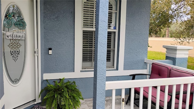 entrance to property featuring stucco siding