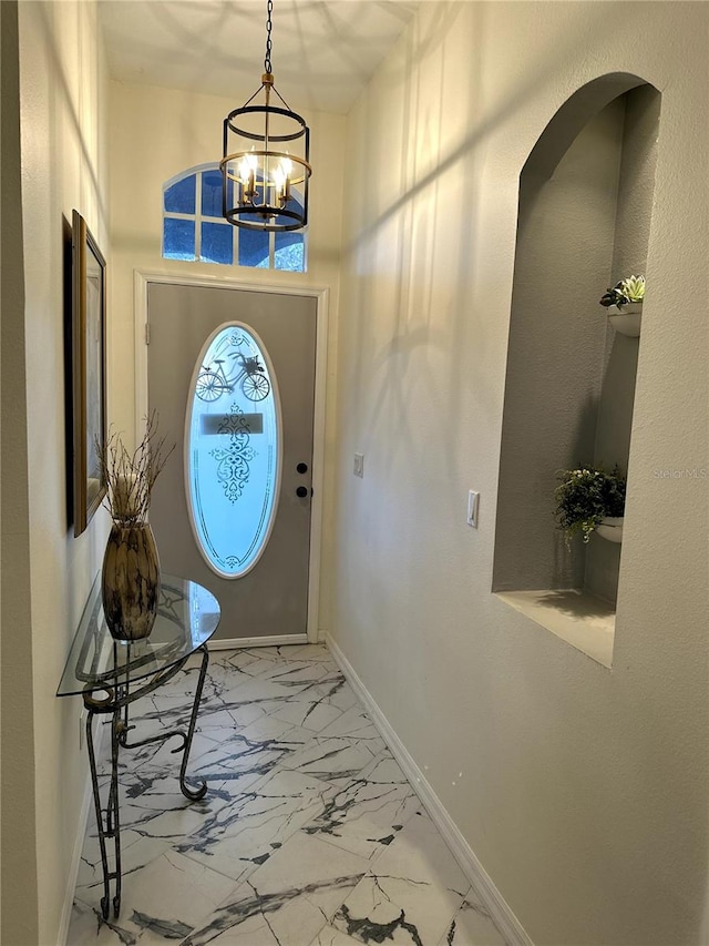12209 Putter Green Ct, New Port Richey, FL 34654 - entrance foyer with marble finish flooring, baseboards, a chandelier, and a high ceiling