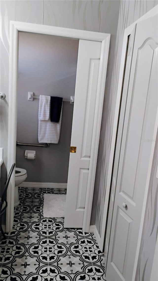 12209 Putter Green Ct, New Port Richey, FL 34654 - bathroom featuring toilet and baseboards