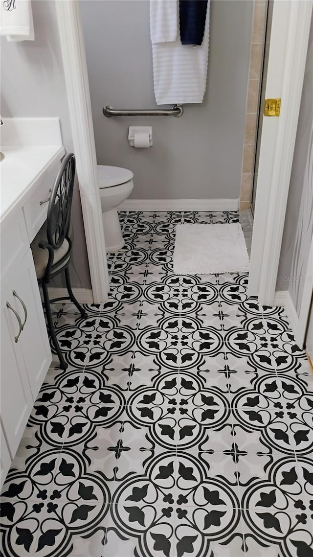 12209 Putter Green Ct, New Port Richey, FL 34654 - full bathroom with toilet, baseboards, vanity, and tile patterned floors