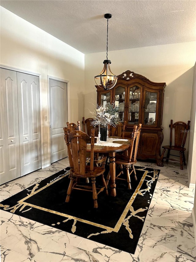 12209 Putter Green Ct, New Port Richey, FL 34654 - dining area with light marble finish floors, a textured ceiling, and a chandelier