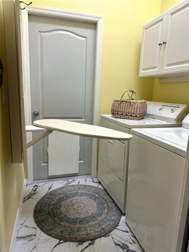 12209 Putter Green Ct, New Port Richey, FL 34654 - clothes washing area featuring light marble finish floors, cabinet space, washer and dryer, and baseboards