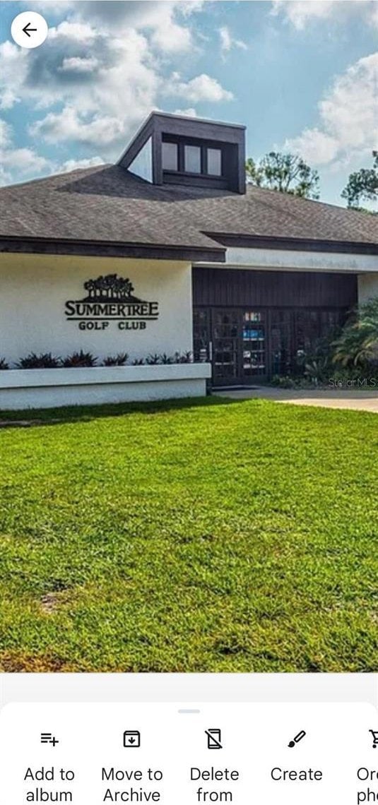12209 Putter Green Ct, New Port Richey, FL 34654 - view of front facade with a front yard and roof with shingles