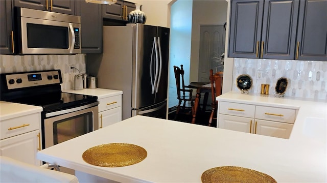 12209 Putter Green Ct, New Port Richey, FL 34654 - kitchen with appliances with stainless steel finishes, tasteful backsplash, light countertops, and white cabinets
