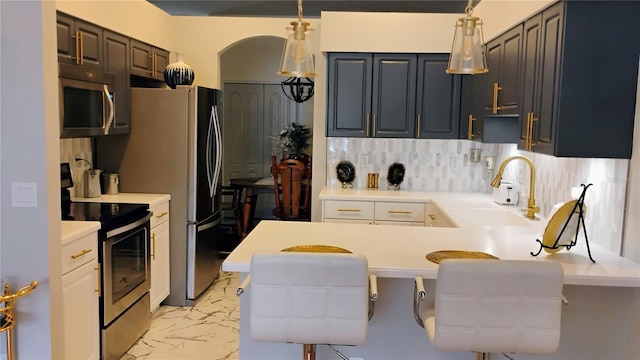 12209 Putter Green Ct, New Port Richey, FL 34654 - kitchen featuring stainless steel appliances, a sink, a peninsula, light countertops, and light marble finish flooring