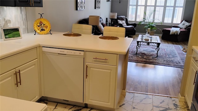 12209 Putter Green Ct, New Port Richey, FL 34654 - kitchen featuring dishwasher, light countertops, a peninsula, and open floor plan