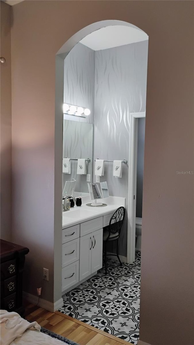 12209 Putter Green Ct, New Port Richey, FL 34654 - bathroom with wood finished floors, vanity, and toilet