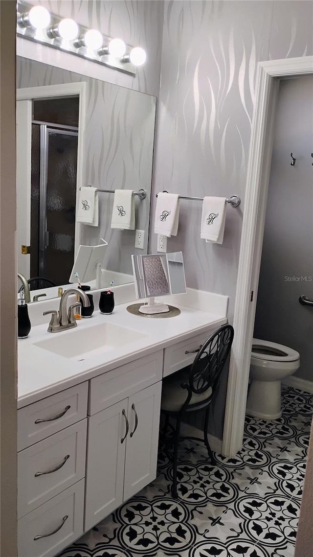 12209 Putter Green Ct, New Port Richey, FL 34654 - bathroom with toilet, vanity, tile patterned flooring, and a shower stall