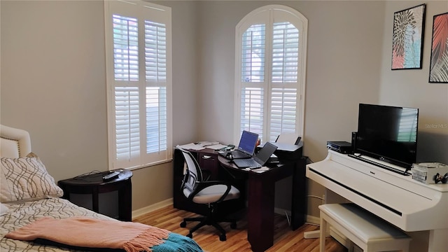 12209 Putter Green Ct, New Port Richey, FL 34654 - bedroom featuring light wood finished floors, baseboards, and a desk