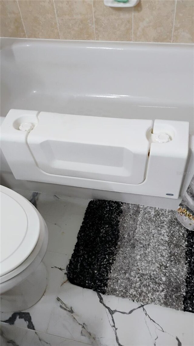 12209 Putter Green Ct, New Port Richey, FL 34654 - bathroom featuring marble finish flooring and toilet