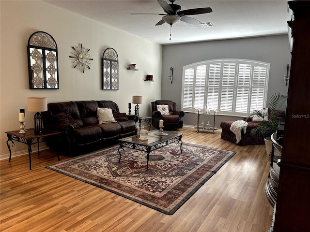 12209 Putter Green Ct, New Port Richey, FL 34654 - living area with a ceiling fan, light wood-style flooring, and baseboards