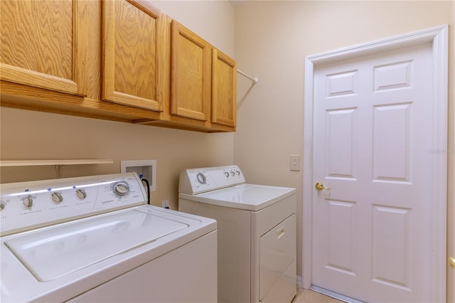 laundry area featuring cabinet space and washer and clothes dryer