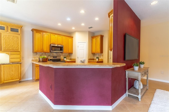 kitchen featuring light tile patterned floors, visible vents, light countertops, appliances with stainless steel finishes, and decorative backsplash