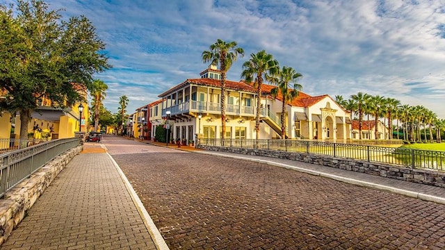 exterior space with street lighting, a residential view, and curbs