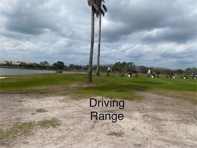 view of street with golf course view and a water view