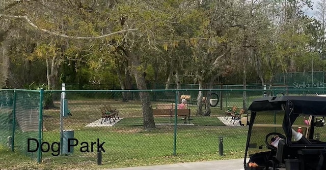 surrounding community featuring fence and a lawn