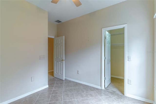 unfurnished bedroom featuring a spacious closet, a closet, visible vents, and baseboards