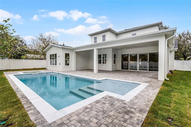 rear view of house with a patio area, a fenced backyard, a lawn, and a fenced in pool