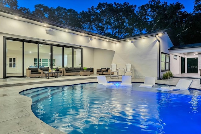 outdoor pool featuring a patio area and an outdoor hangout area