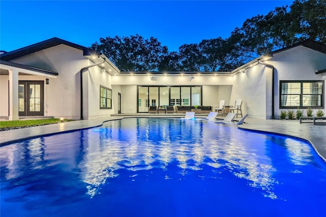 pool featuring french doors and a patio area