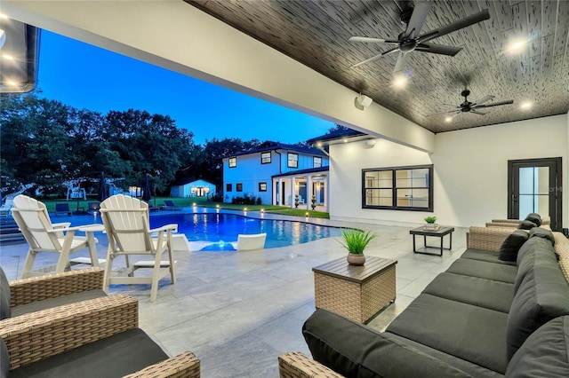 outdoor pool featuring ceiling fan, a patio, and an outdoor hangout area