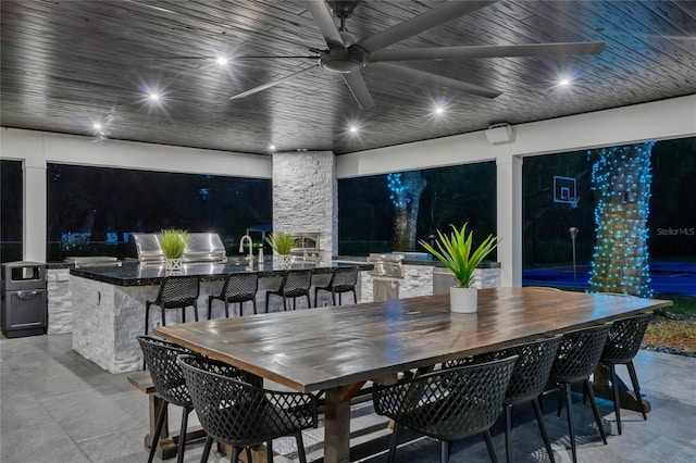 view of patio with a ceiling fan, outdoor wet bar, and a sink