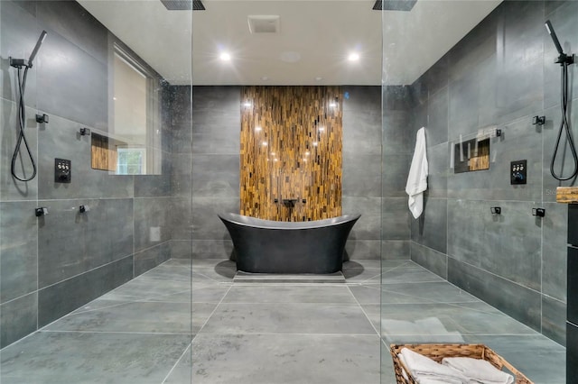 full bathroom with a freestanding tub, walk in shower, and recessed lighting