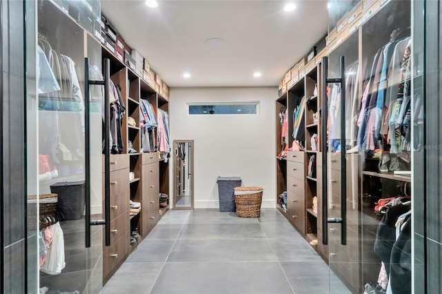 walk in closet with tile patterned flooring