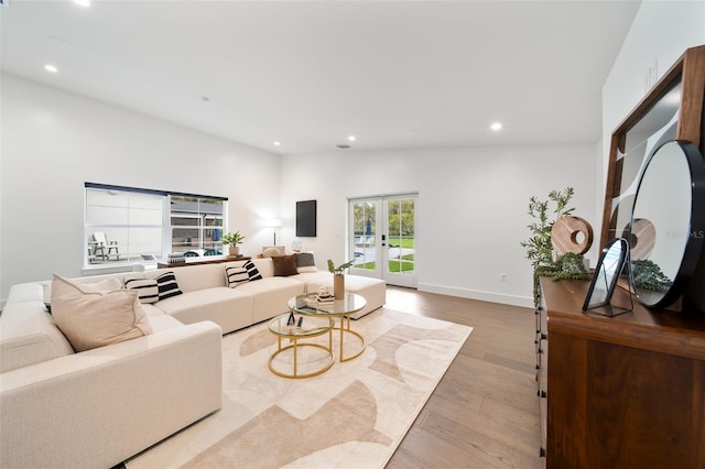 living room featuring recessed lighting, wood finished floors, baseboards, vaulted ceiling, and french doors