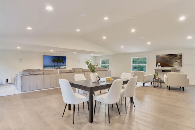 dining area with light wood-type flooring, vaulted ceiling, and recessed lighting