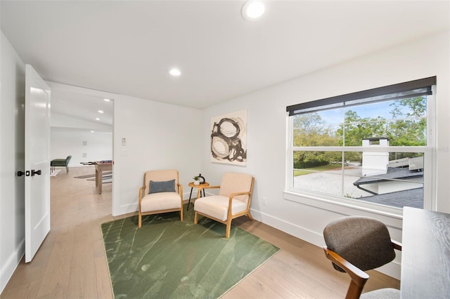 living area featuring recessed lighting, baseboards, and wood finished floors