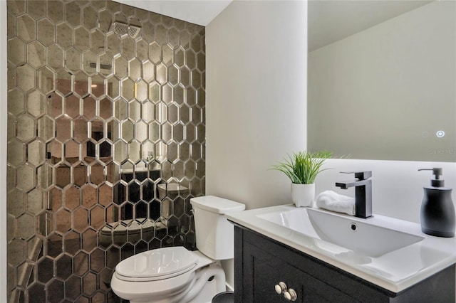 bathroom featuring vanity, toilet, and walk in shower