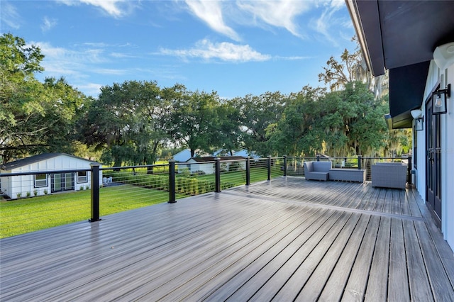 wooden terrace featuring outdoor lounge area and a lawn