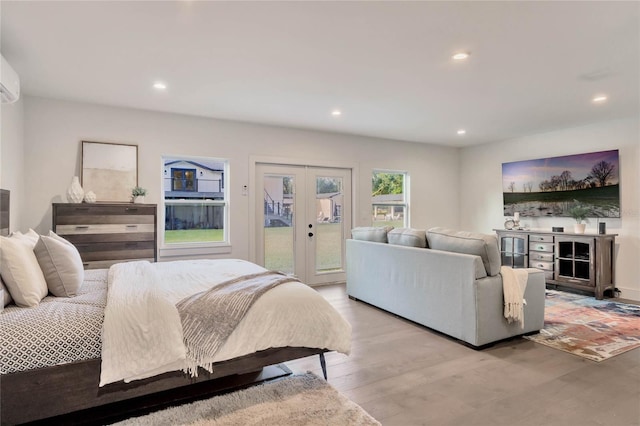 bedroom with access to exterior, light wood-type flooring, french doors, and recessed lighting