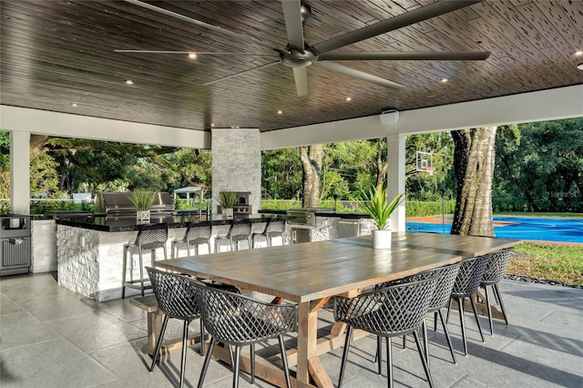 view of patio / terrace with ceiling fan, area for grilling, and outdoor wet bar