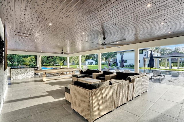 view of patio / terrace featuring an outdoor hangout area, ceiling fan, a shed, and an outbuilding