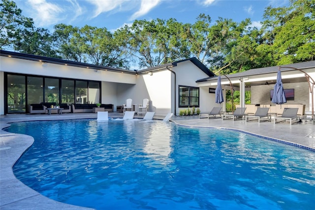 outdoor pool featuring a patio area and outdoor lounge area