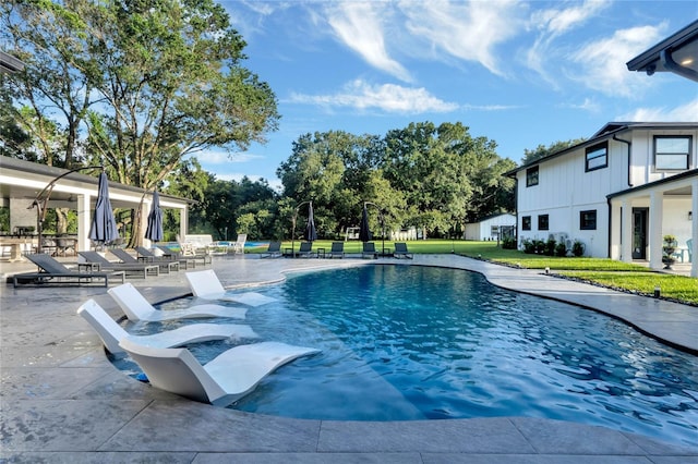 pool featuring a yard and a patio area