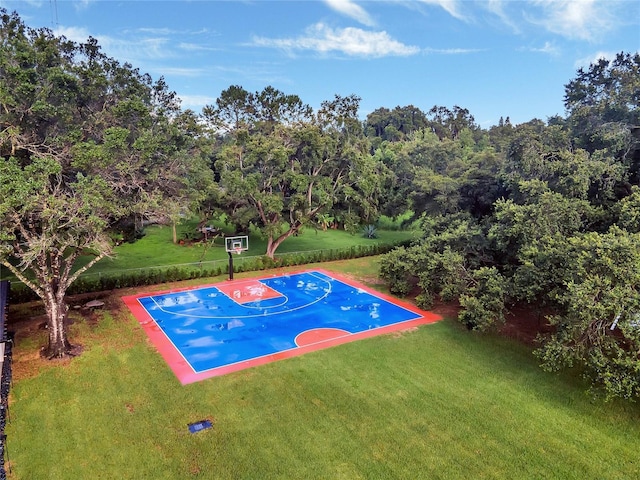 view of sport court featuring basketball court and a lawn