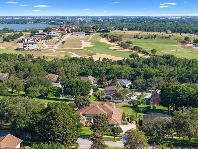 drone / aerial view featuring view of golf course and a water view