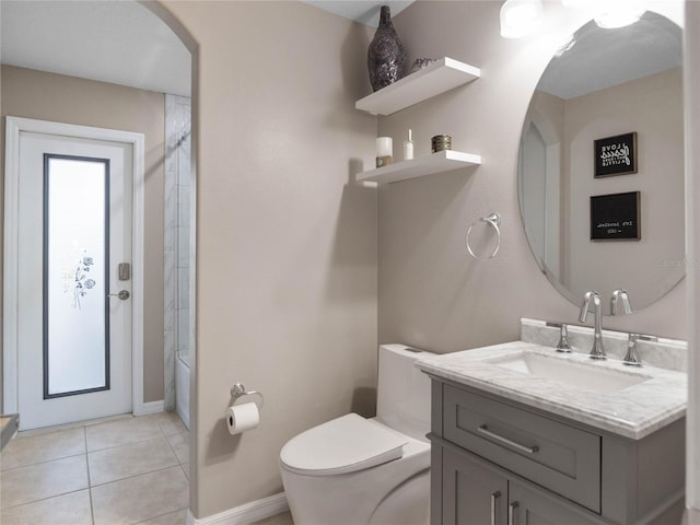 bathroom featuring toilet, vanity, shower / tub combination, tile patterned flooring, and baseboards