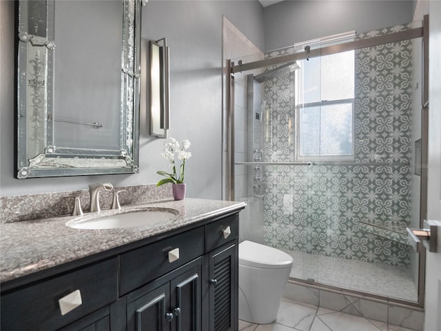 full bathroom with marble finish floor, toilet, vanity, and a shower stall