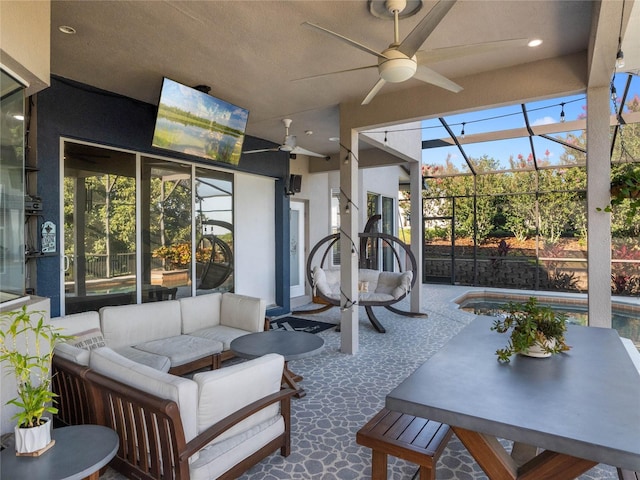 sunroom featuring a ceiling fan and a healthy amount of sunlight