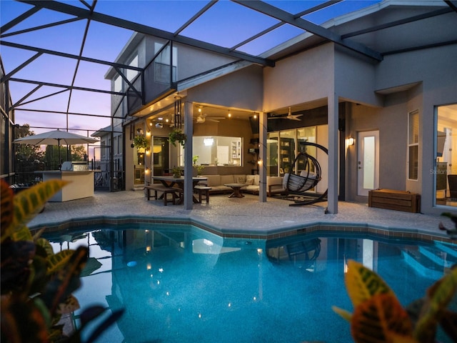 pool with a lanai, a patio area, ceiling fan, and an outdoor hangout area