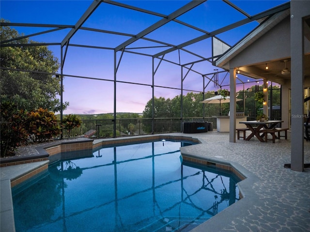 view of pool featuring glass enclosure, ceiling fan, a fenced in pool, and a patio