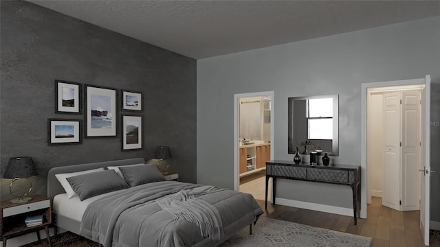 bedroom featuring light wood-style floors and baseboards